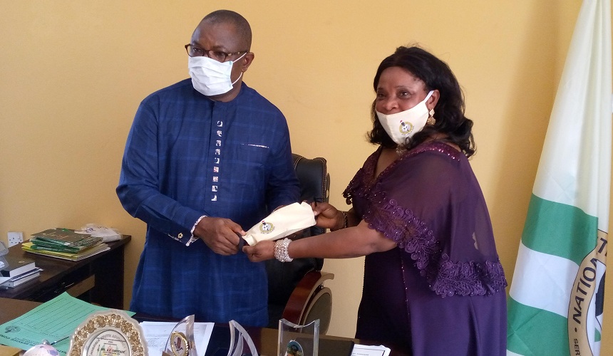 L-R: Mr. Benjamin Omotade, NYSC South-South Director and Mrs. Olutayo Samuel, NYSC Delta State Coordinator during a presentation of souvenir to mark the NYSC 47th Anniversary on Friday, May 22, 2020