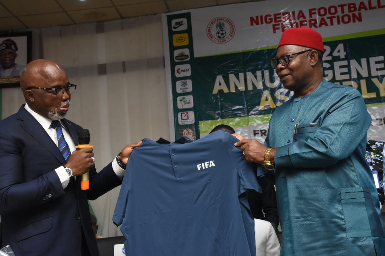 Delta State Deputy Governor Sir. Monday Onyeme (right) Receiving a FIFA Tagged T-shirt from the FIFA representative, Mr Amaju Pinick during the 80th annual general assembly of the Nigeria football federation (NFF) held at Unity Hall Government House Asaba on Friday, October 4, 2024